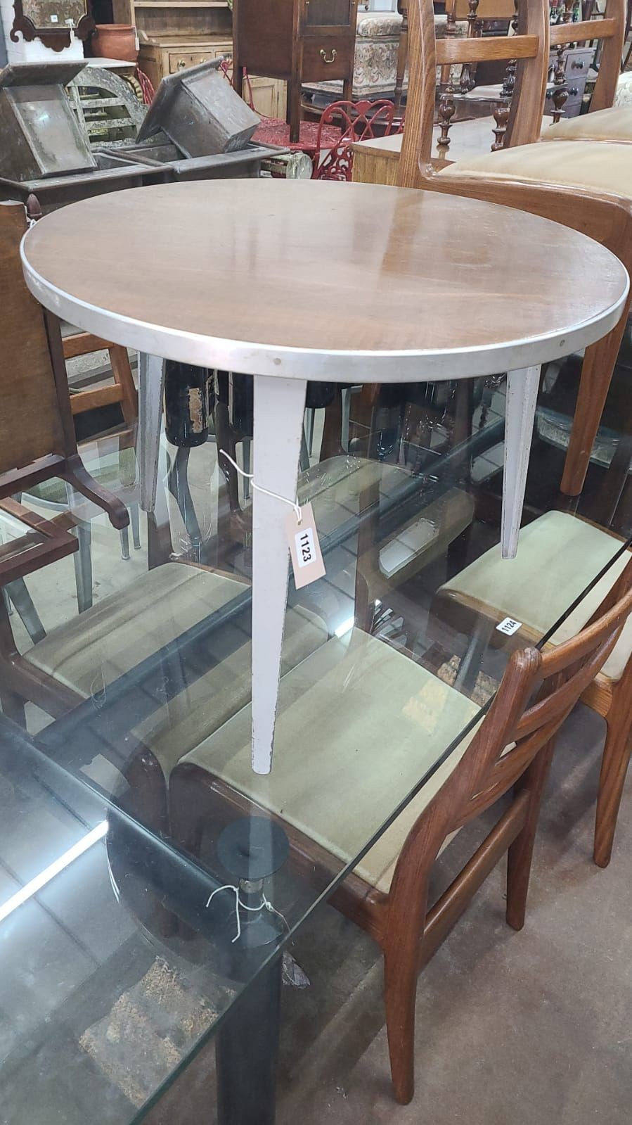 An Ernest Race occasional table, labelled, diameter 60 cms, height 46 cms.